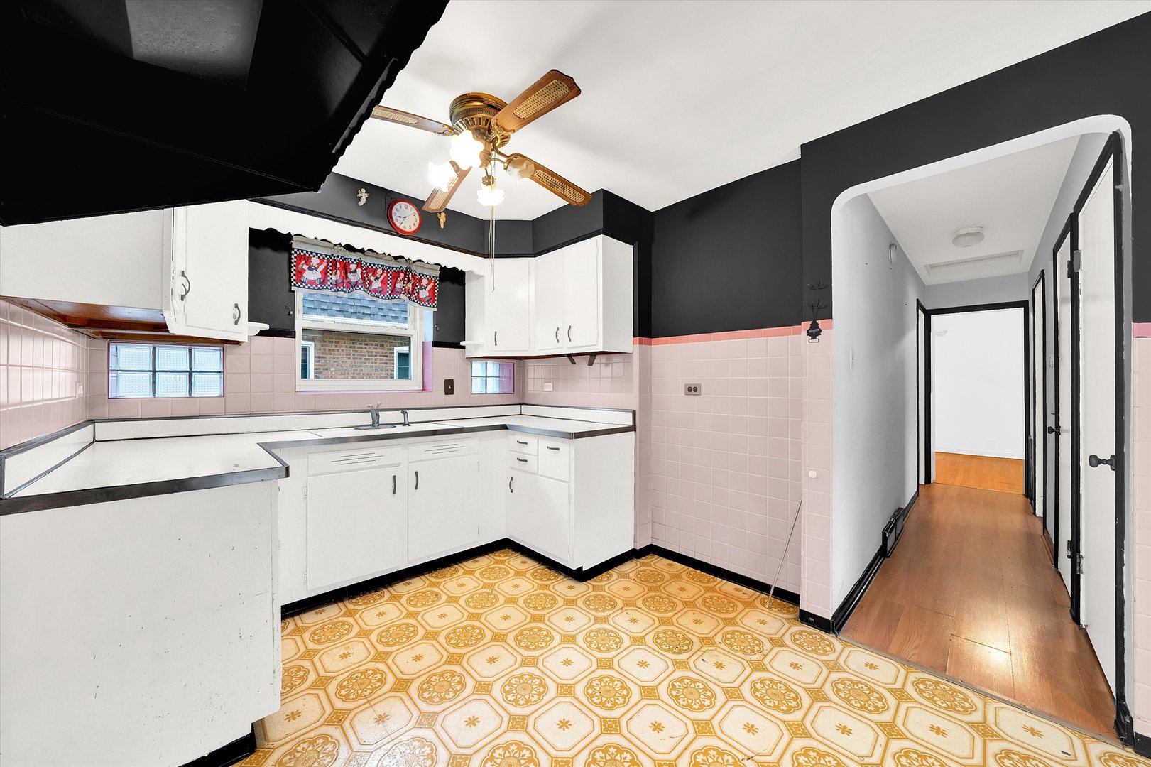 3933 West 58th Street Chicago, IL 60629 - Photo 18 of 32 a kitchen with a stove a refrigerator and cabinets