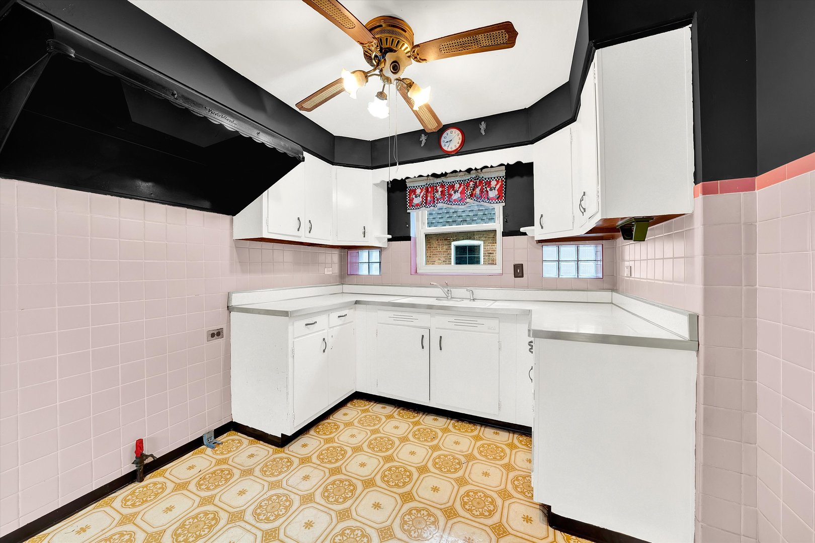 3933 West 58th Street Chicago, IL 60629 - Photo 21 of 32 a kitchen with a stove a sink and a refrigerator