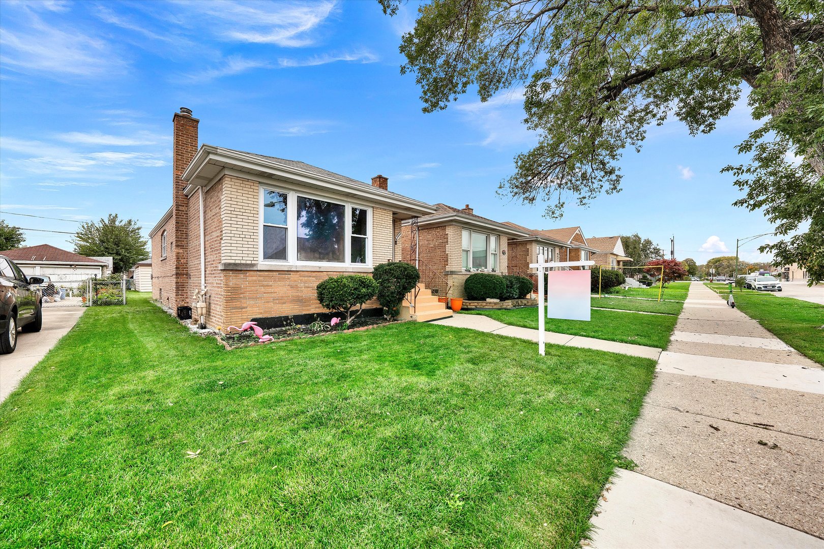3933 West 58th Street Chicago, IL 60629 - Photo 27 of 32 a front view of house with yard and green space