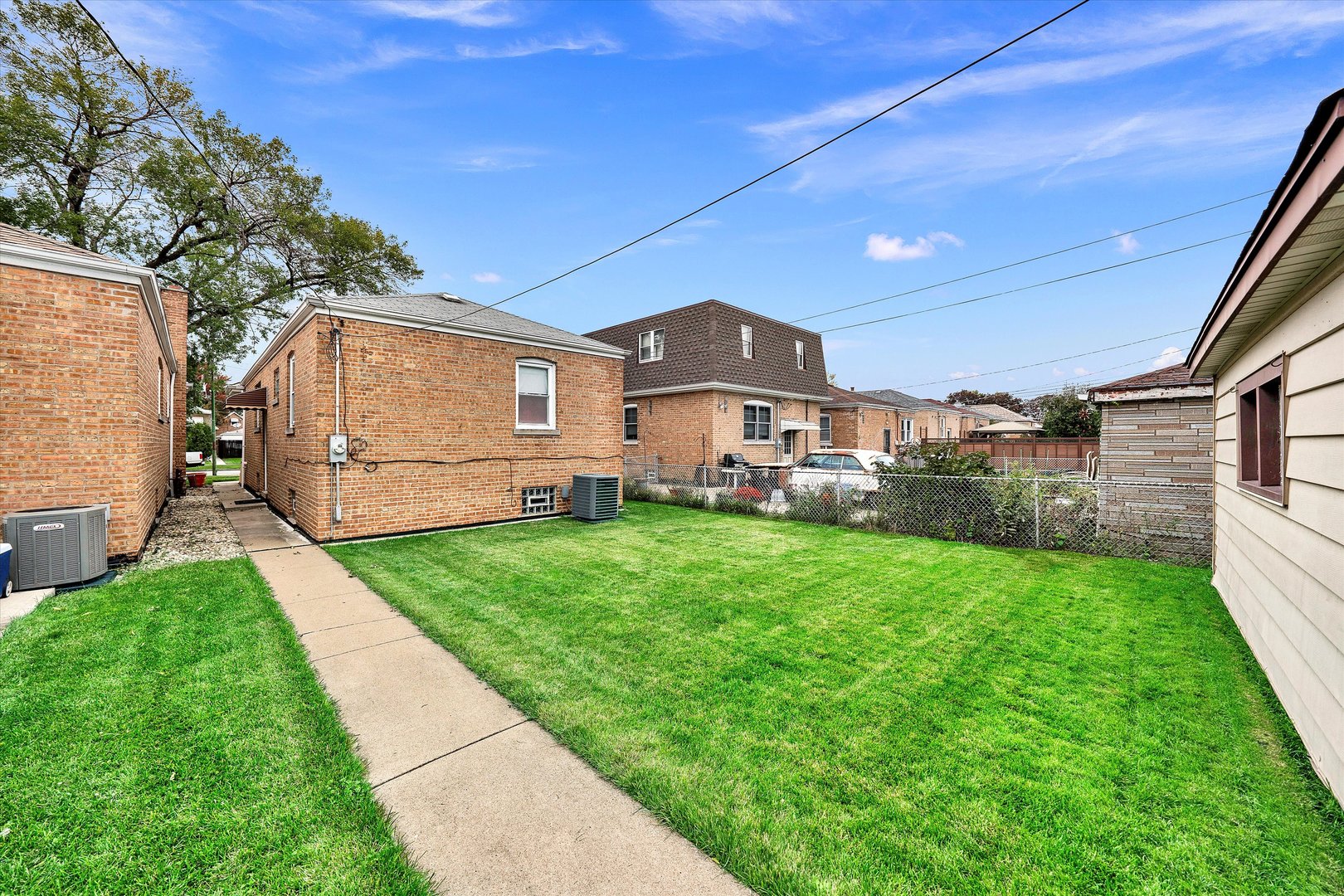 3933 West 58th Street Chicago, IL 60629 - Photo 29 of 32 a front view of a house with a yard