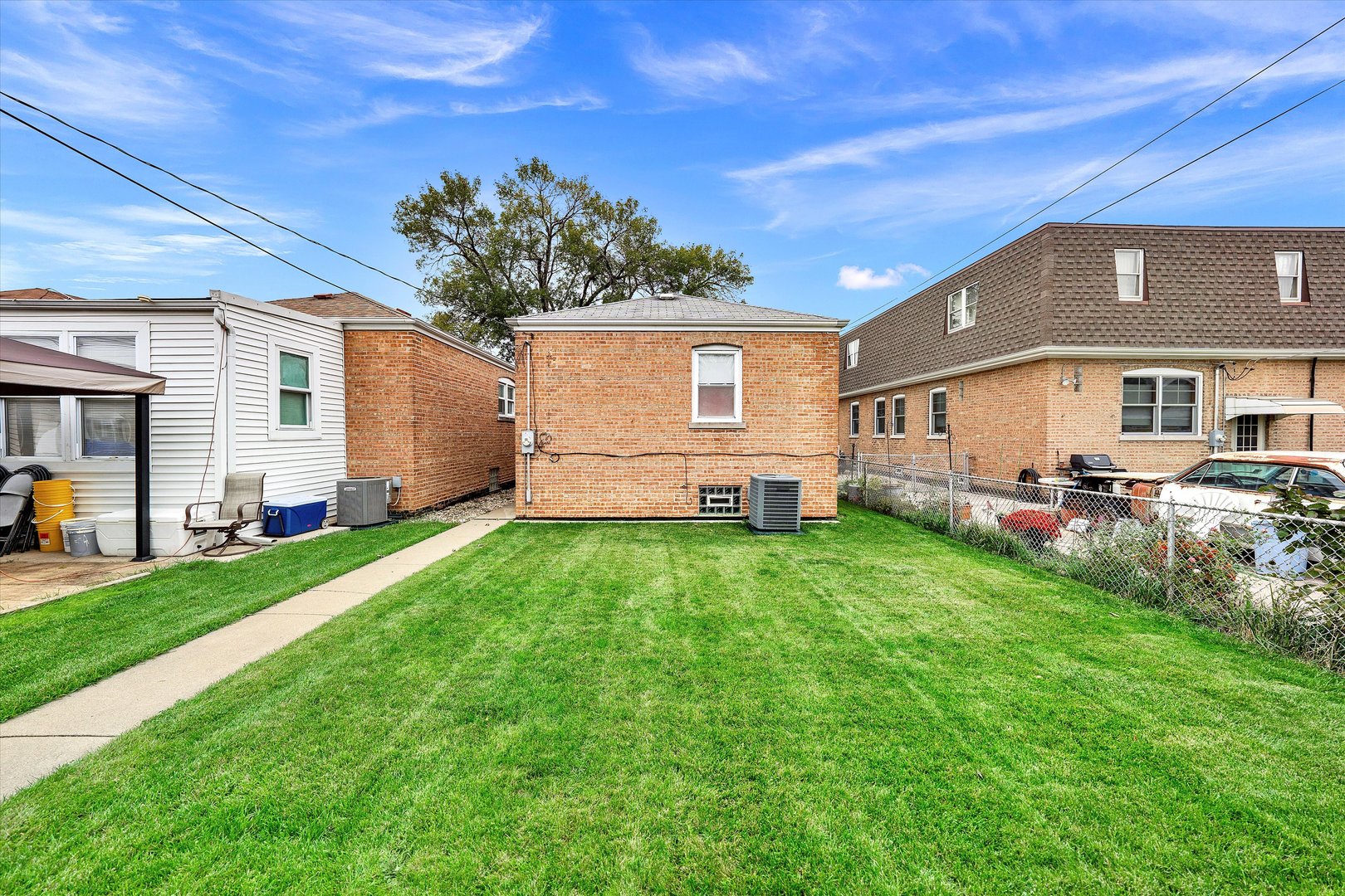 3933 West 58th Street Chicago, IL 60629 - Photo 30 of 32 a front view of house with yard and trees