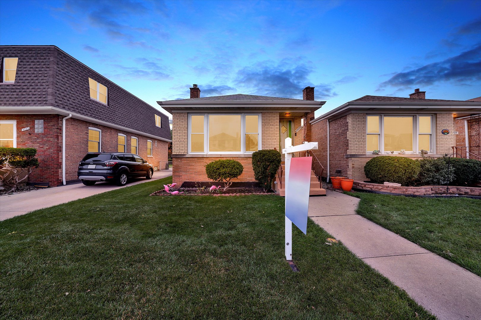 3933 West 58th Street Chicago, IL 60629 - Photo 31 of 32 a front view of a house with a garden and plants