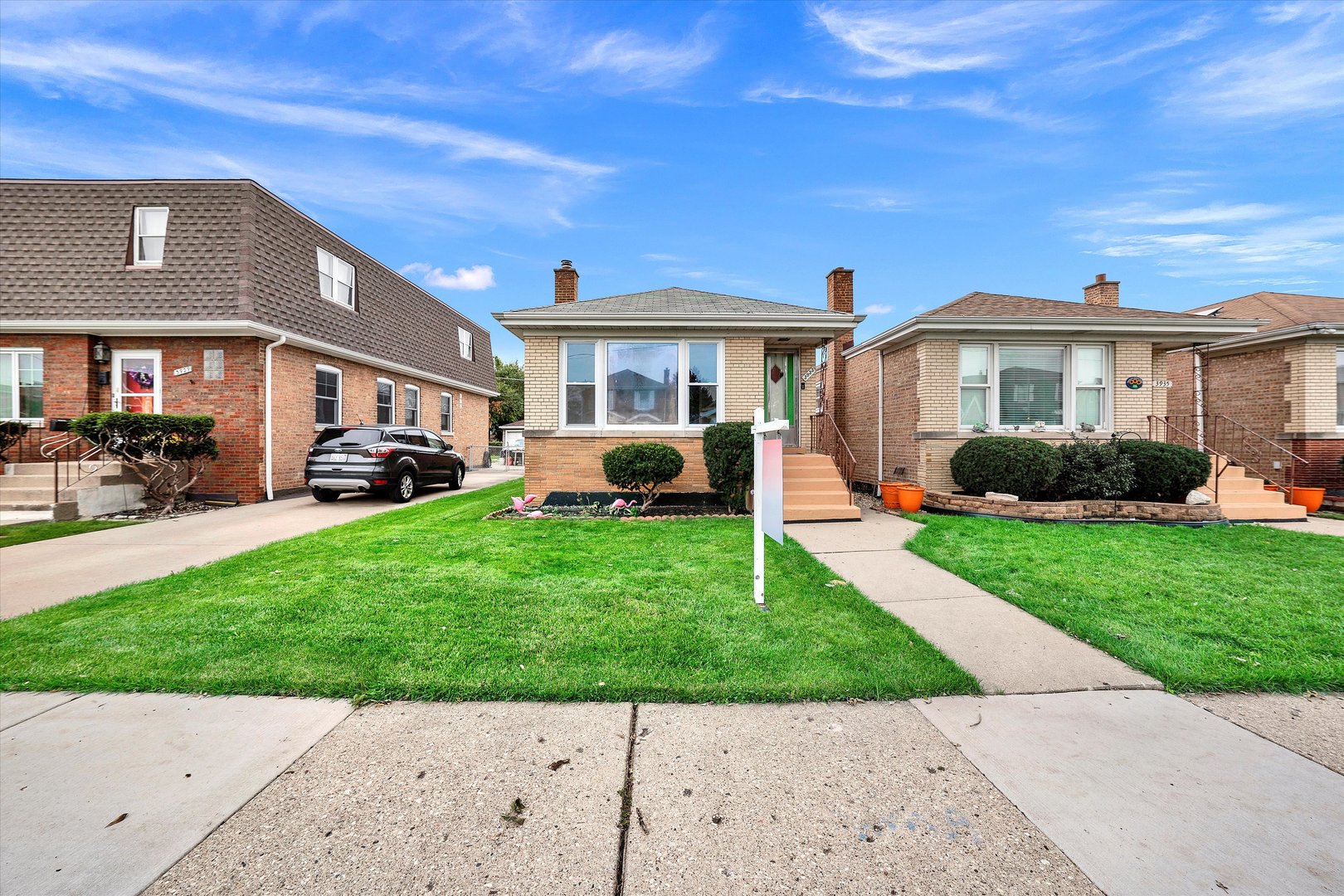 3933 West 58th Street Chicago, IL 60629 - Photo 32 of 32 a front view of a house with a garden and trees