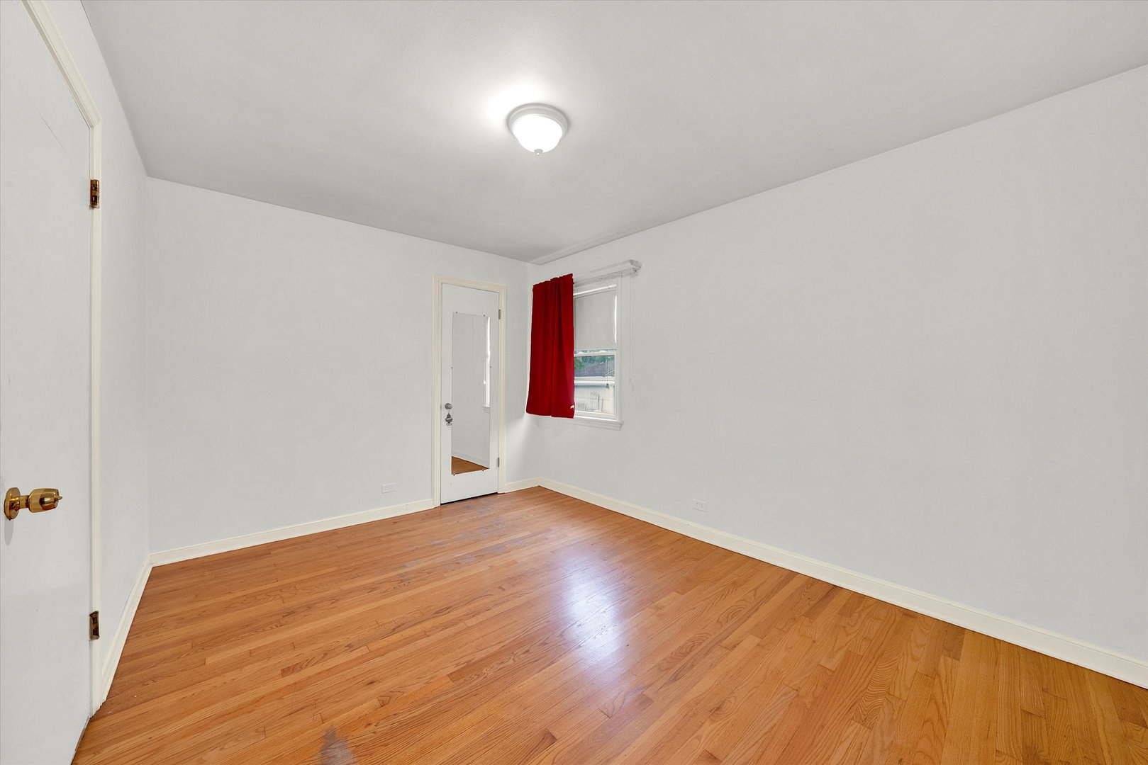 3933 West 58th Street Chicago, IL 60629 - Photo 8 of 32 an empty room with wooden floor and windows