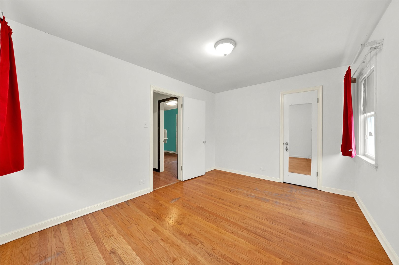 3933 West 58th Street Chicago, IL 60629 - Photo 9 of 32 a bedroom with a bed and a wooden floor