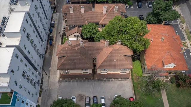 an aerial view of a house with yard and lake view