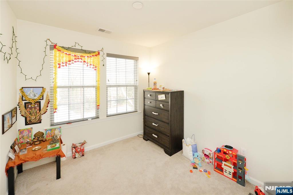 12-48 Plaza Road Fair Lawn, NJ 07410 - Photo 13 of 26 a living room with furniture and a window