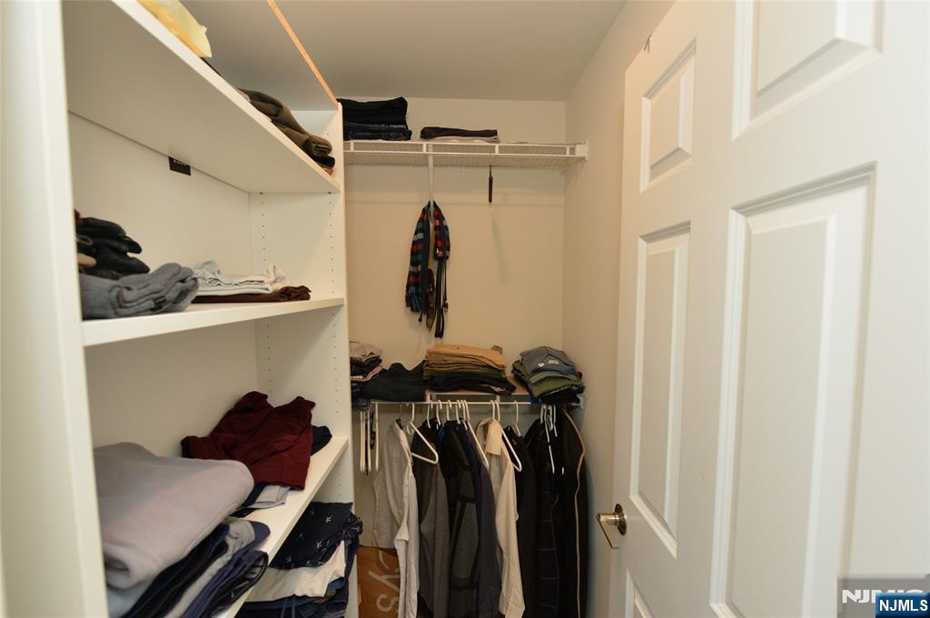 12-48 Plaza Road Fair Lawn, NJ 07410 - Photo 15 of 26 a view of walk in closet with clothes and shoes