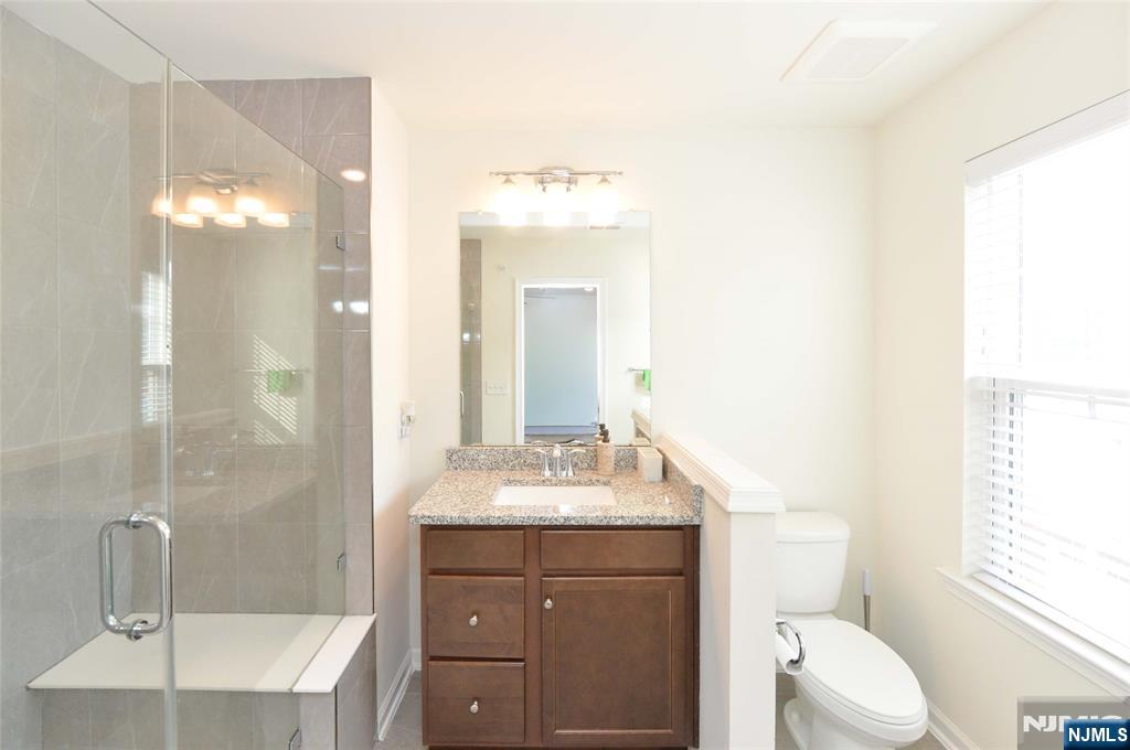 12-48 Plaza Road Fair Lawn, NJ 07410 - Photo 17 of 26 a bathroom with a sink a toilet and shower