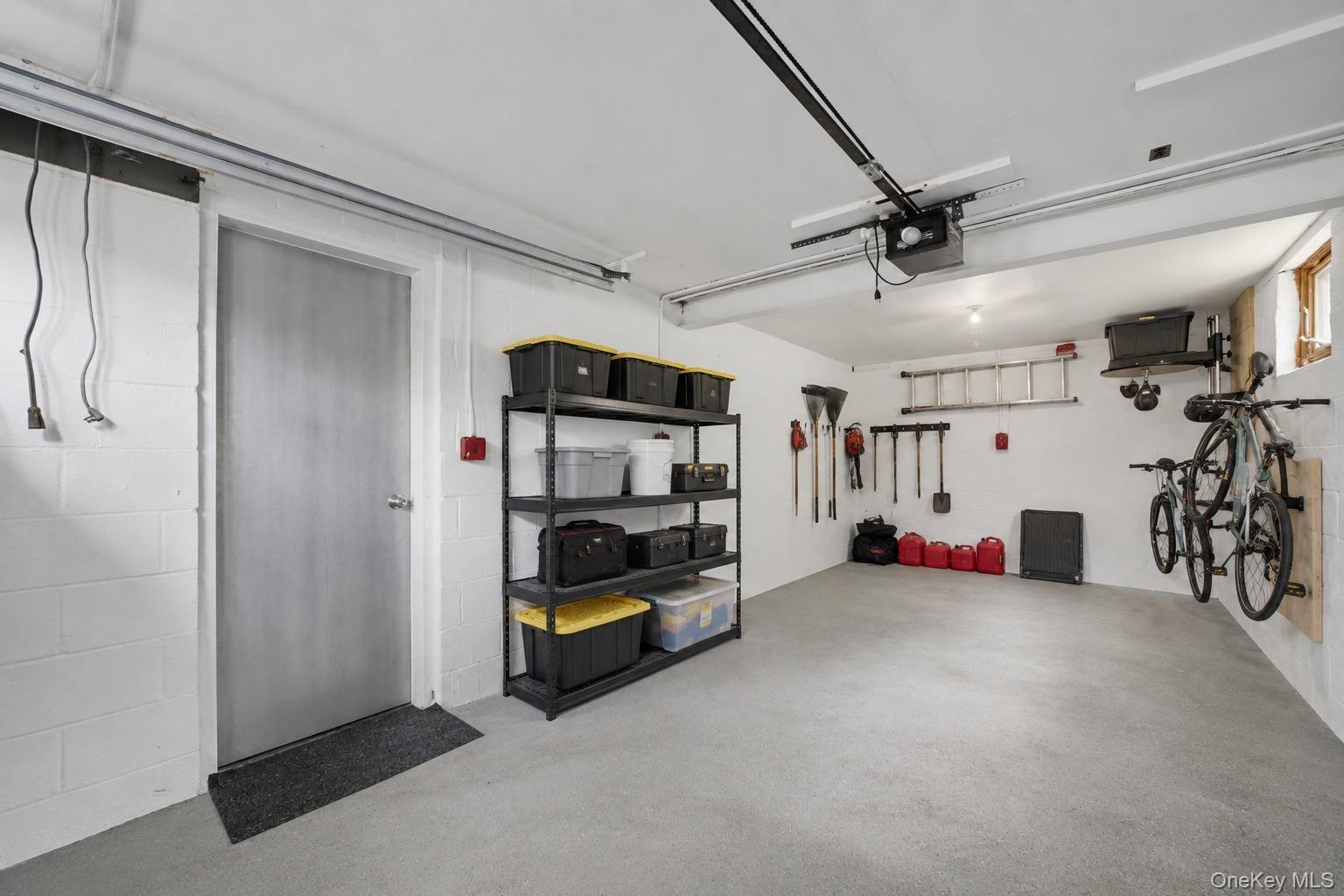 144 Bell Road Scarsdale, NY 10583 - Photo 37 of 49 Spacious garage featuring a concrete floor, painted cinder block walls, and an overhead garage door opener mechanism
