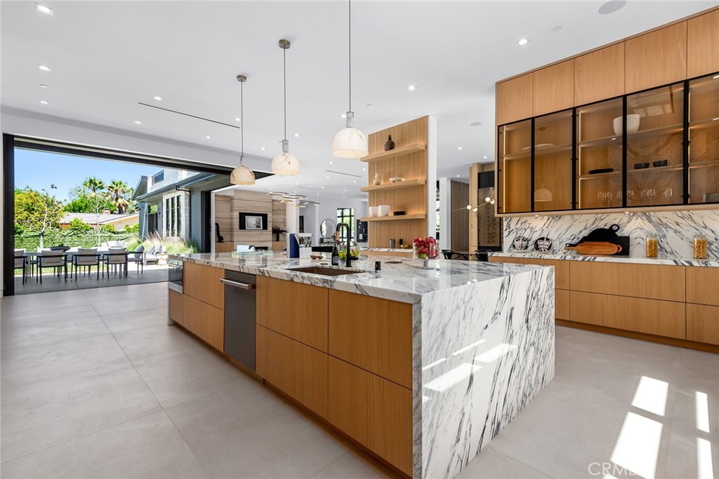 23650 Long Valley Road Hidden Hills, CA 91302 - Photo 14 of 57 a large kitchen with stainless steel appliances kitchen island granite countertop a sink and cabinets