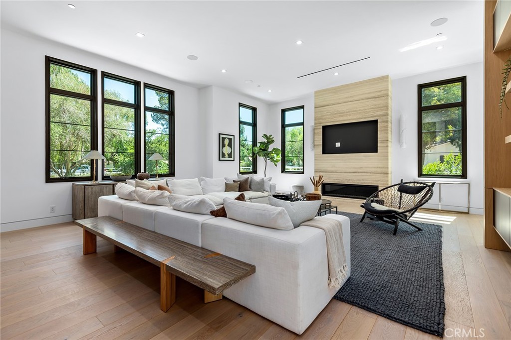 23650 Long Valley Road Hidden Hills, CA 91302 - Photo 20 of 57 a living room with furniture large window and flat screen tv