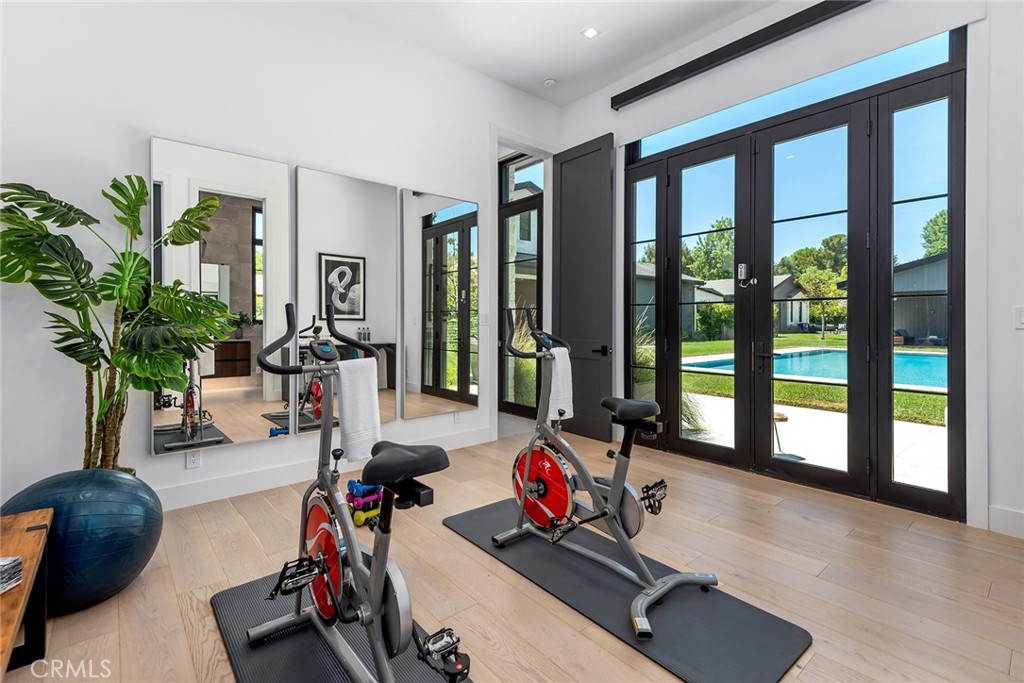 23650 Long Valley Road Hidden Hills, CA 91302 - Photo 25 of 57 a room with gym equipment and a large window