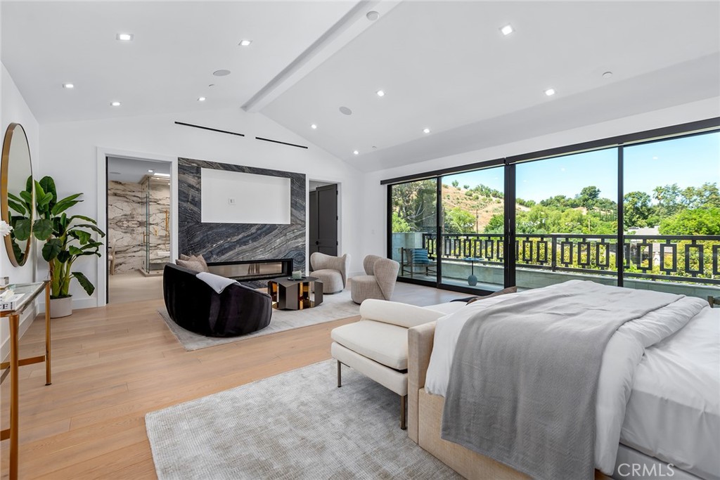 23650 Long Valley Road Hidden Hills, CA 91302 - Photo 28 of 57 a spacious bedroom with a large bed and a large window