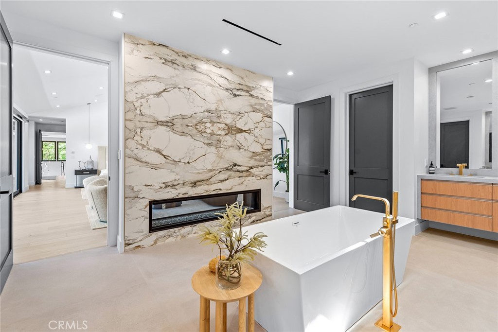 23650 Long Valley Road Hidden Hills, CA 91302 - Photo 30 of 57 a living room with stainless steel appliances furniture a fireplace and a chandelier