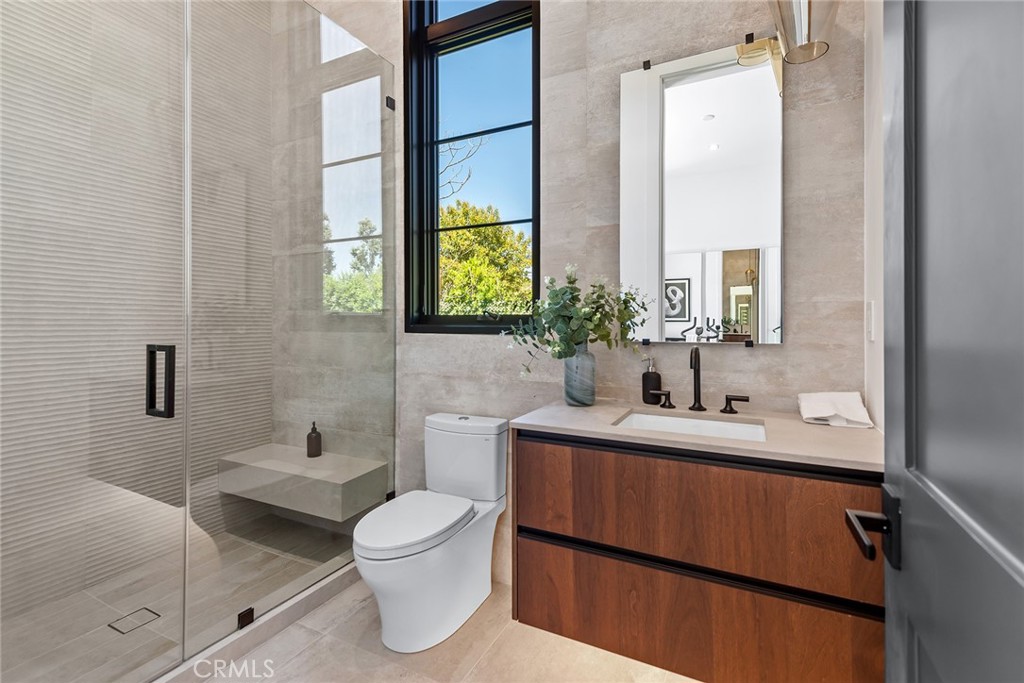 23650 Long Valley Road Hidden Hills, CA 91302 - Photo 37 of 57 a bathroom with a toilet sink and mirror
