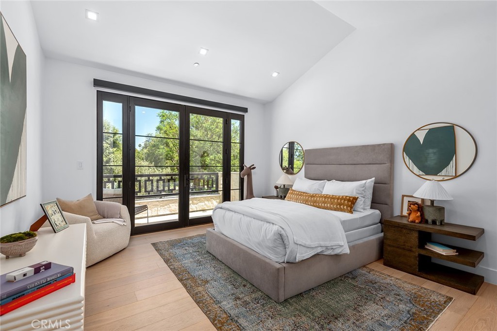 23650 Long Valley Road Hidden Hills, CA 91302 - Photo 38 of 57 a bedroom with a bed a lamp and a large window