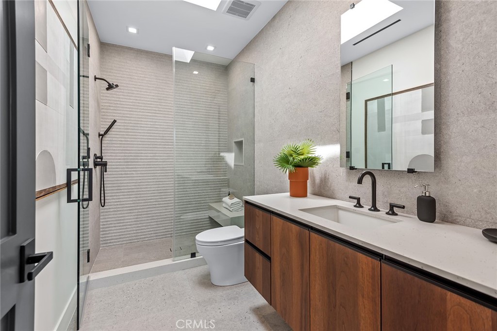 23650 Long Valley Road Hidden Hills, CA 91302 - Photo 39 of 57 a bathroom with a double vanity sink toilet and shower