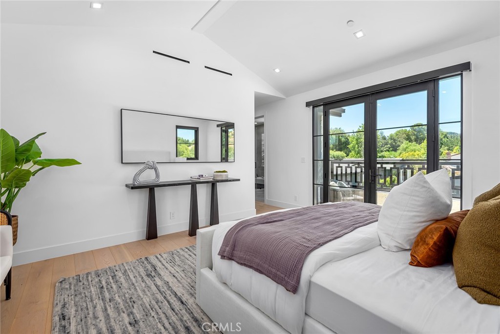 23650 Long Valley Road Hidden Hills, CA 91302 - Photo 40 of 57 a bedroom with a bed window and potted plant on the dresser