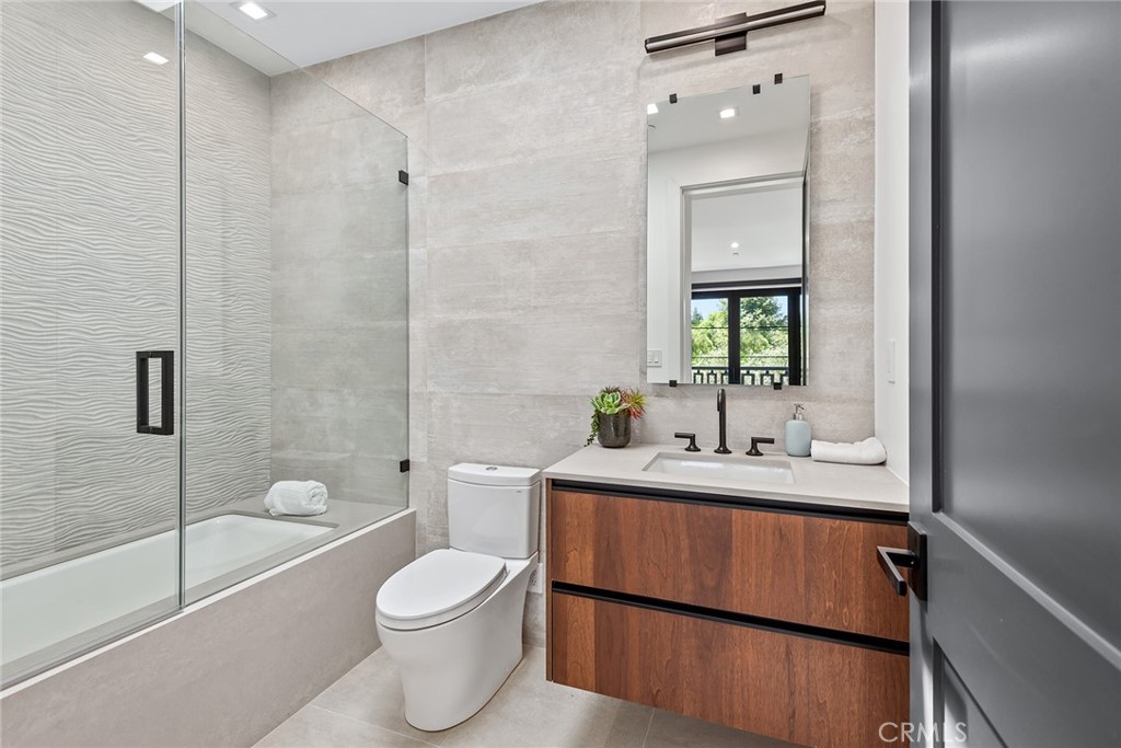 23650 Long Valley Road Hidden Hills, CA 91302 - Photo 41 of 57 a bathroom with a toilet a sink and a bathtub