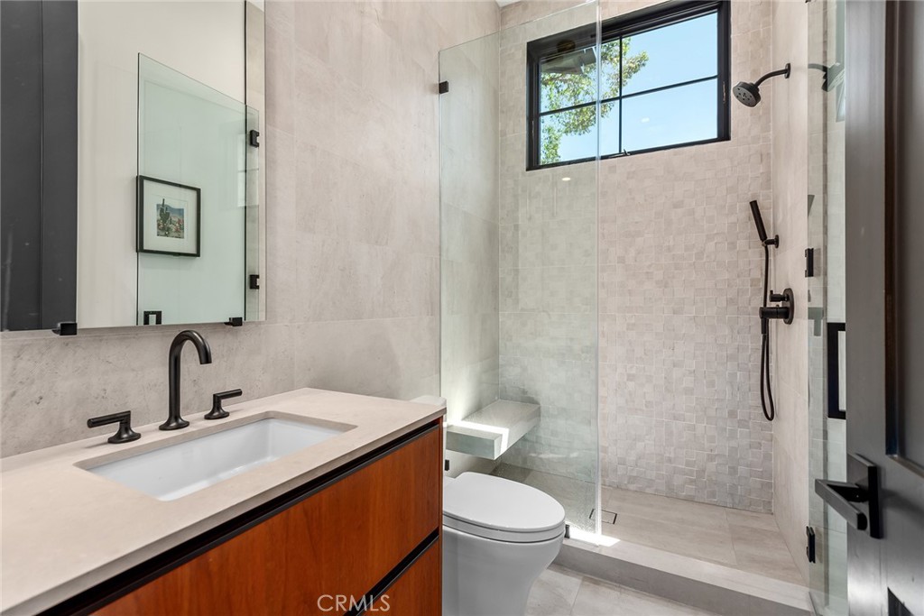 23650 Long Valley Road Hidden Hills, CA 91302 - Photo 45 of 57 a bathroom with a sink toilet and shower