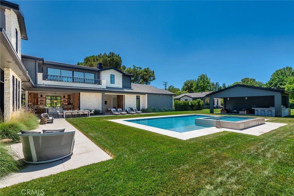 23650 Long Valley Road Hidden Hills, CA 91302 - Photo 53 of 57 a front view of a house with swimming pool having outdoor seating