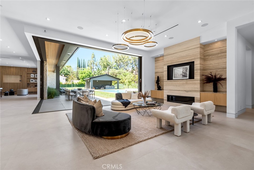 23650 Long Valley Road Hidden Hills, CA 91302 - Photo 9 of 57 a living room with furniture fireplace and a large window