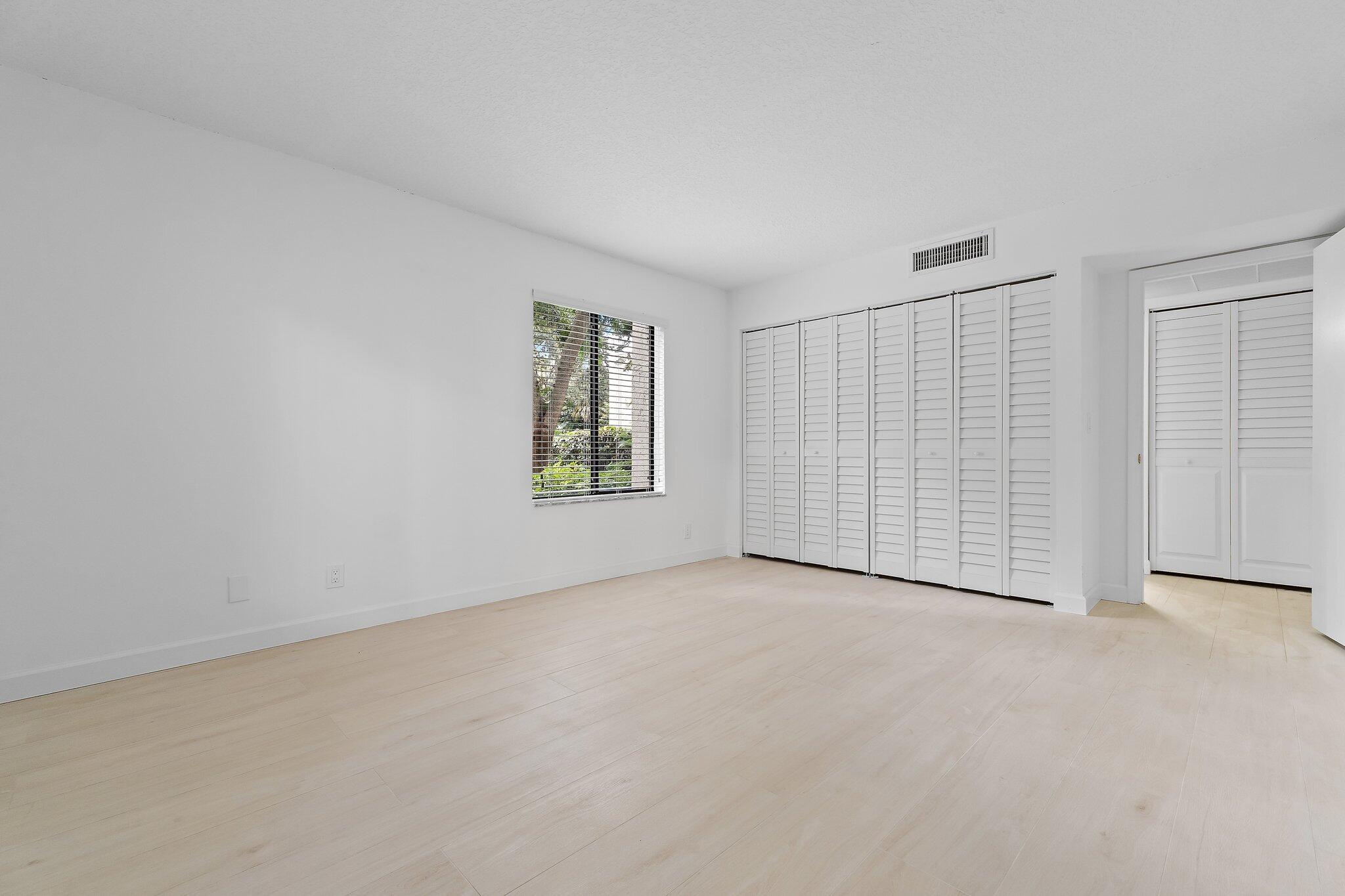 150 Pineview Road, Unit I4 Jupiter, FL 33469 - Photo 11 of 13 an empty room with windows