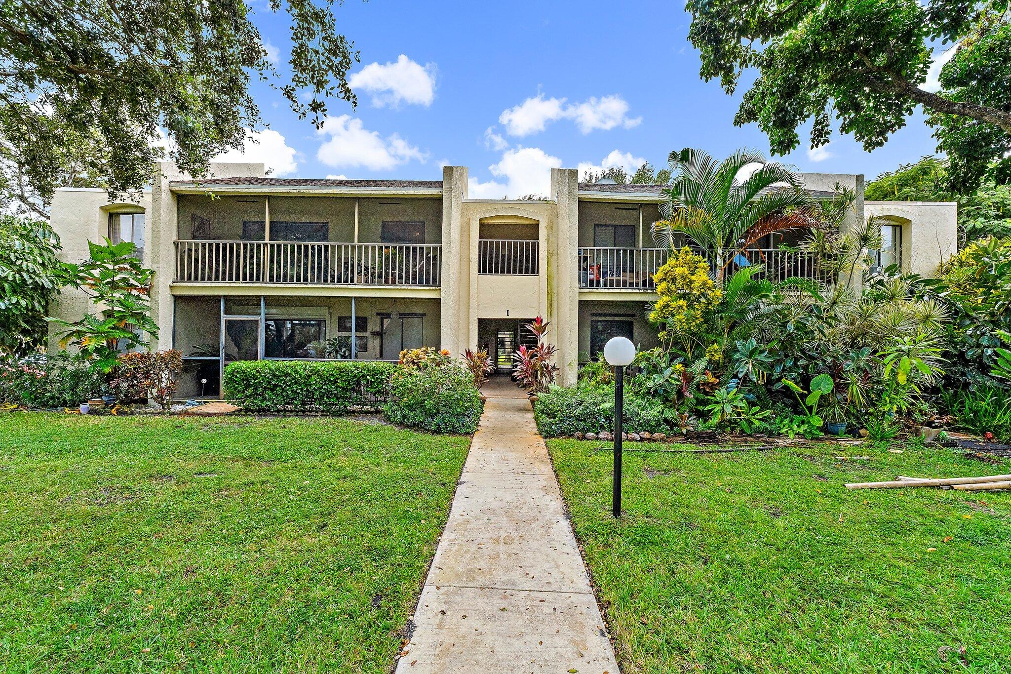 150 Pineview Road, Unit I4 Jupiter, FL 33469 - Photo 13 of 13 a front view of building with yard
