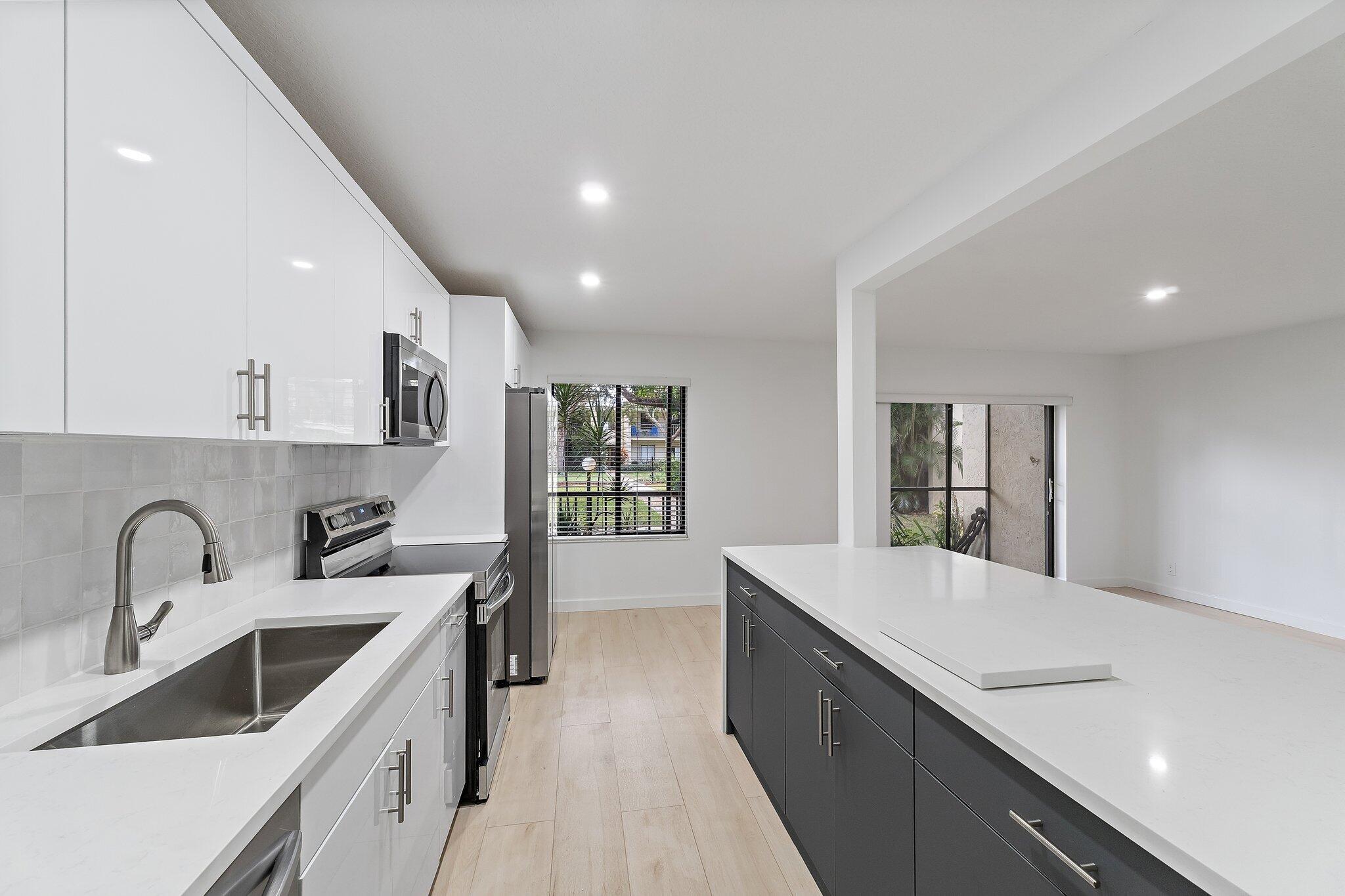 150 Pineview Road, Unit I4 Jupiter, FL 33469 - Photo 2 of 13 a kitchen with sink and cabinets