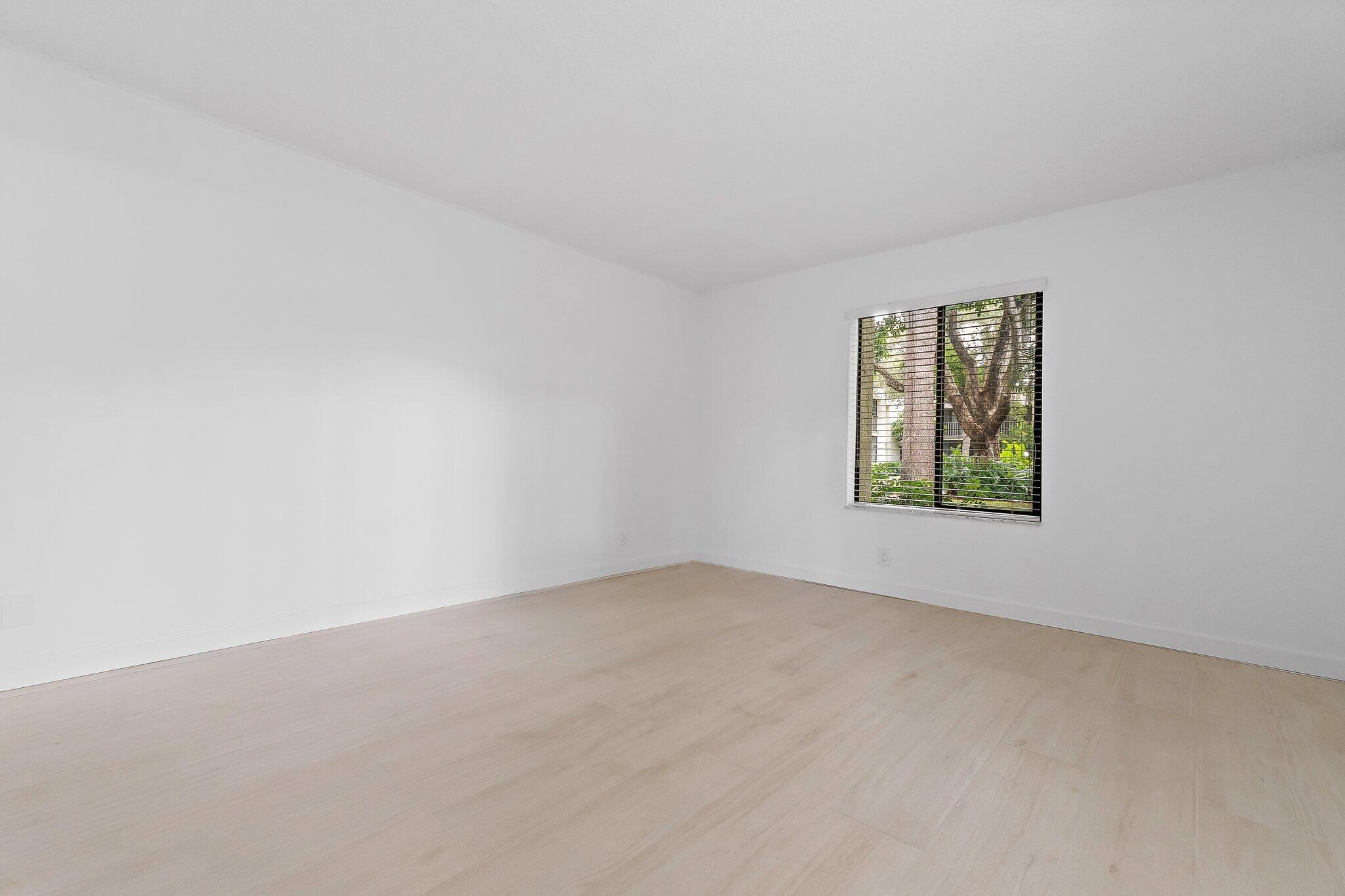 150 Pineview Road, Unit I4 Jupiter, FL 33469 - Photo 10 of 13 an empty room with a window