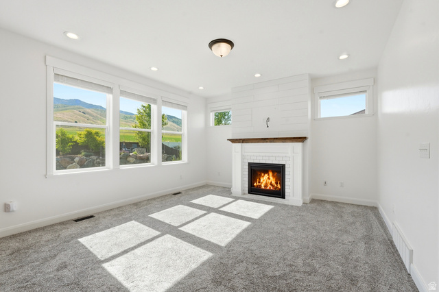 338 Windy Rdg Drive Smithfield, UT 84335 - Photo 17 of 63 Living area with a fireplace featuring a white subway tile surround and a wood mantel