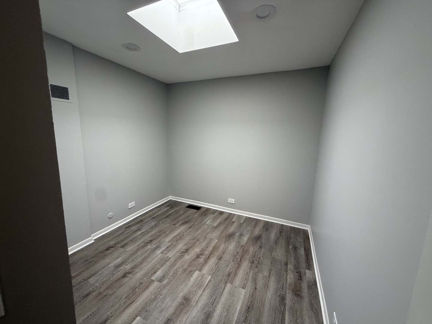 744 West Gordon Terrace, Unit 301 Chicago, IL 60613 - Photo 11 of 13 an empty room with wooden floor and windows