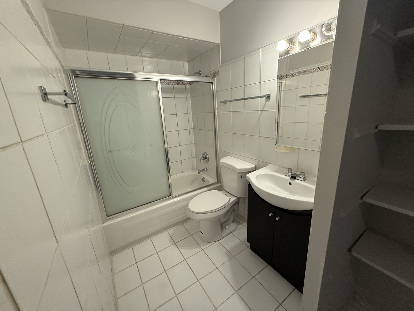 744 West Gordon Terrace, Unit 301 Chicago, IL 60613 - Photo 13 of 13 a bathroom with a toilet a sink and shower