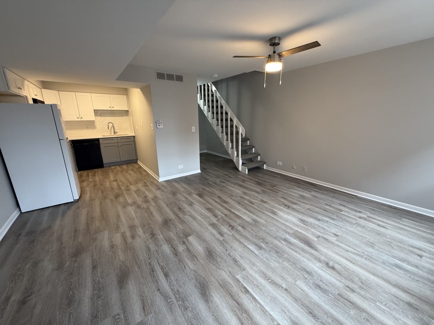 744 West Gordon Terrace, Unit 301 Chicago, IL 60613 - Photo 2 of 13 wooden floor in an empty room with a window