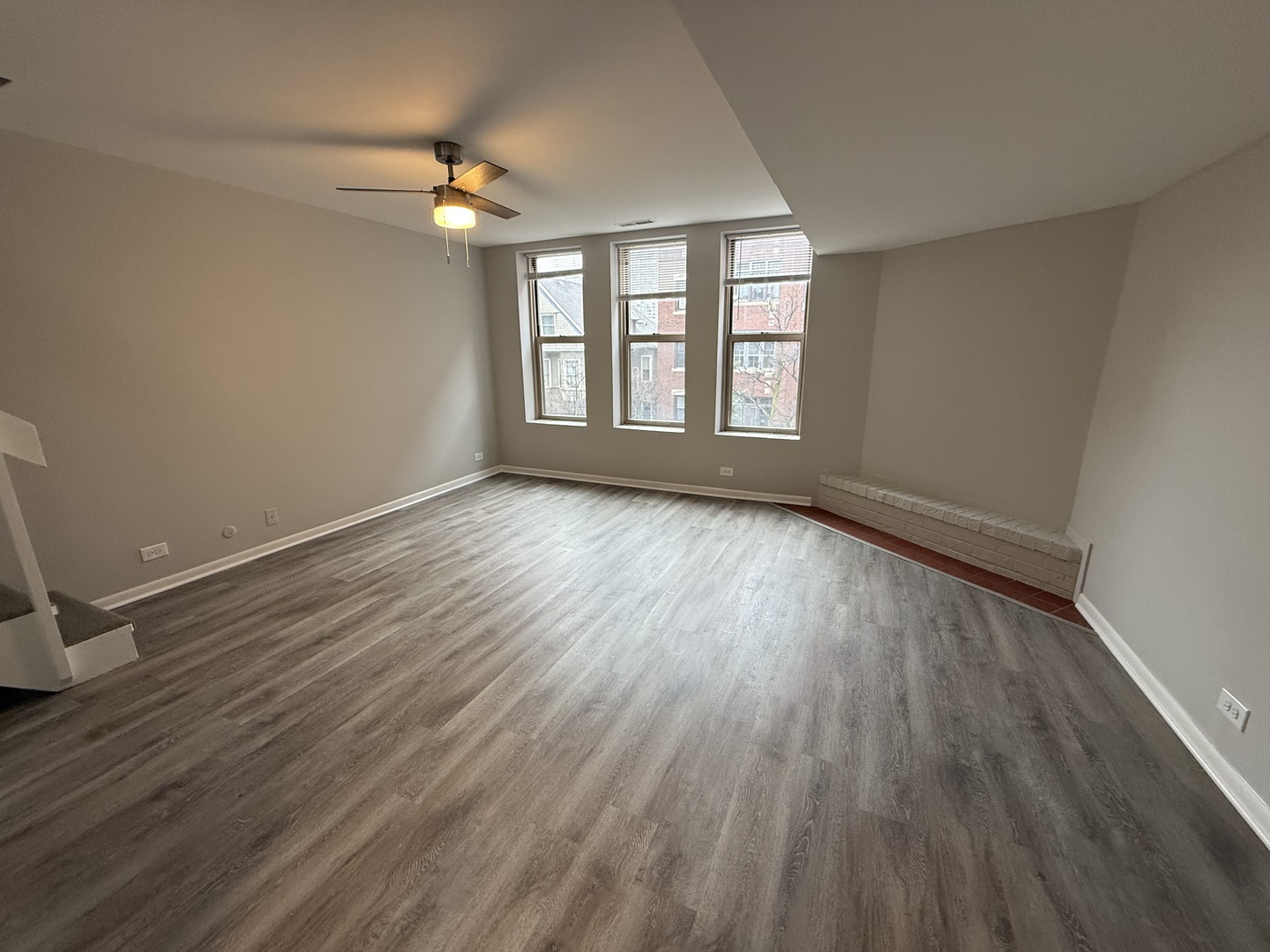 744 West Gordon Terrace, Unit 301 Chicago, IL 60613 - Photo 4 of 13 a view of an empty room with wooden floor and a window