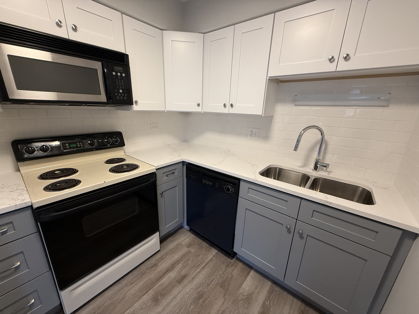 744 West Gordon Terrace, Unit 301 Chicago, IL 60613 - Photo 6 of 13 a kitchen with stainless steel appliances granite countertop a stove microwave and sink