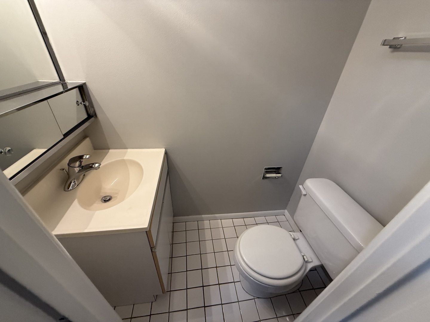 744 West Gordon Terrace, Unit 301 Chicago, IL 60613 - Photo 7 of 13 a white toilet sitting next to a bathroom sink