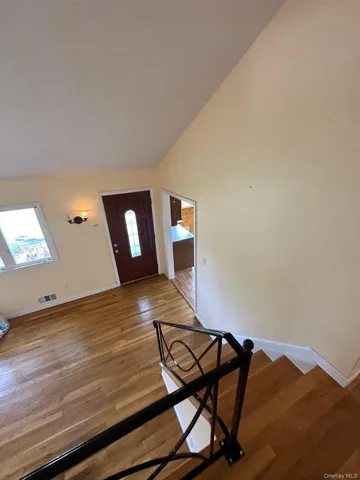 a view of a living room and wooden floor