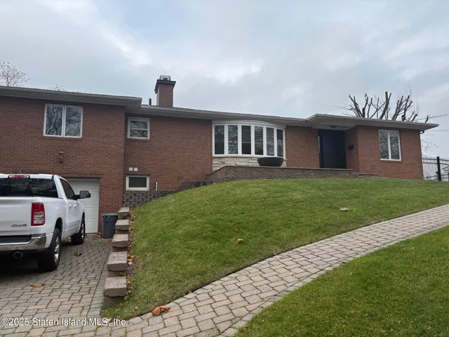 a front view of a house with a garden