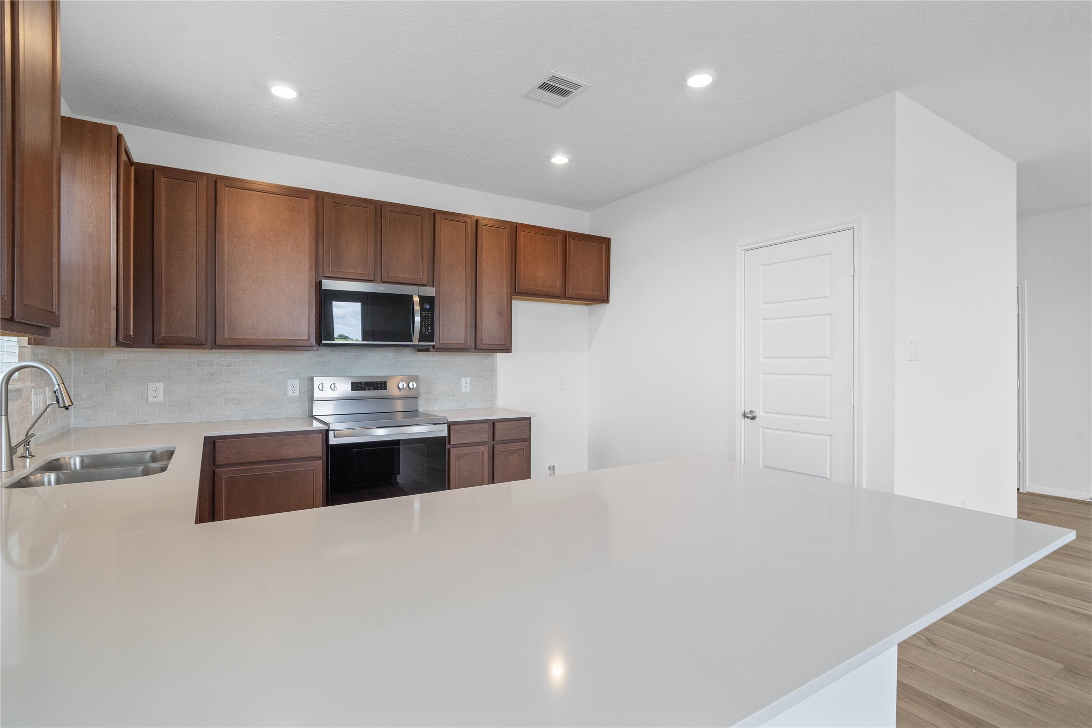 7210 Brooklea Road Beasley, TX 77417 - Photo 14 of 32 Featured here is the Miami White Silestone quartz countertops.