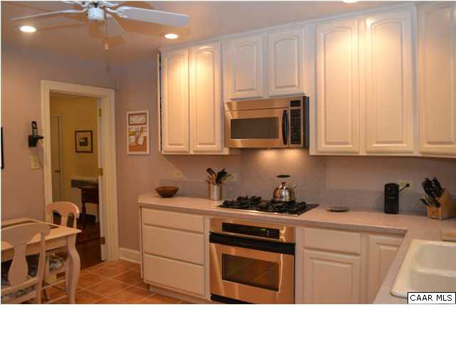 1715 Meadowbrook Heights Road Charlottesville, VA 22901 - Photo 7 of 23 New Corian countertops, cabinetry, tiled floor, gas cooktop.