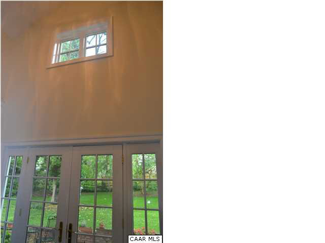 1715 Meadowbrook Heights Road Charlottesville, VA 22901 - Photo 10 of 23 Light streams into the two story breezeway with slate floor. Doors lead to brick patio in backyard.