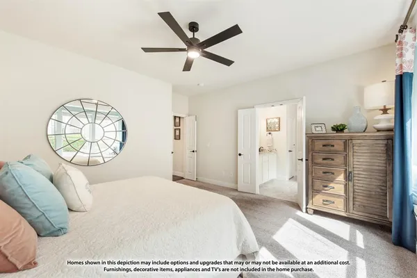 a bedroom with a large bed and a chandelier
