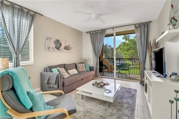 a living room with furniture tv and a flat screen tv