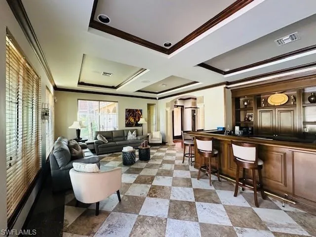 a living room with large window and furniture