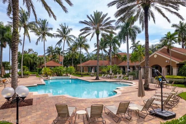 1200 Reserve Way, Unit 201 Naples, FL 34105 - Photo 12 of 20 a view of a house with swimming pool and a chairs