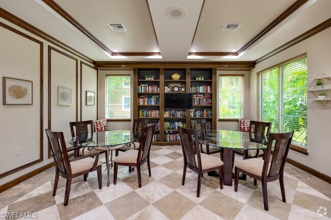 1200 Reserve Way, Unit 201 Naples, FL 34105 - Photo 13 of 20 a view of a dining room with furniture window and outside view