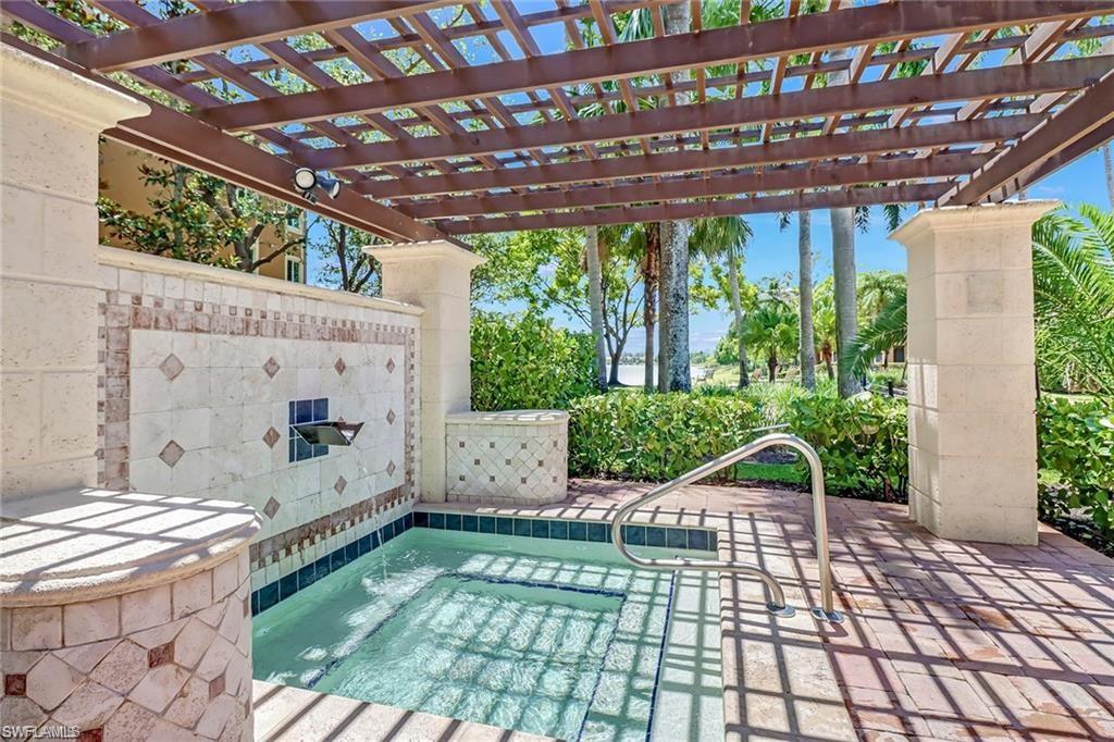 1200 Reserve Way, Unit 201 Naples, FL 34105 - Photo 19 of 20 a view of a porch with furniture and yard
