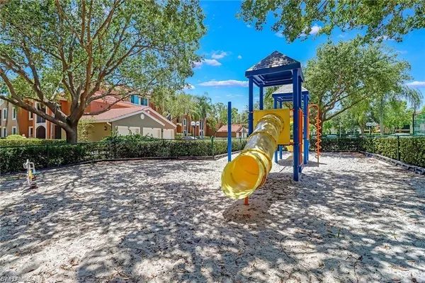 a view of a swimming pool with a backyard and trees